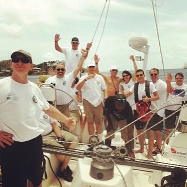 International Air Rally crew waving from the deck of a sailboat