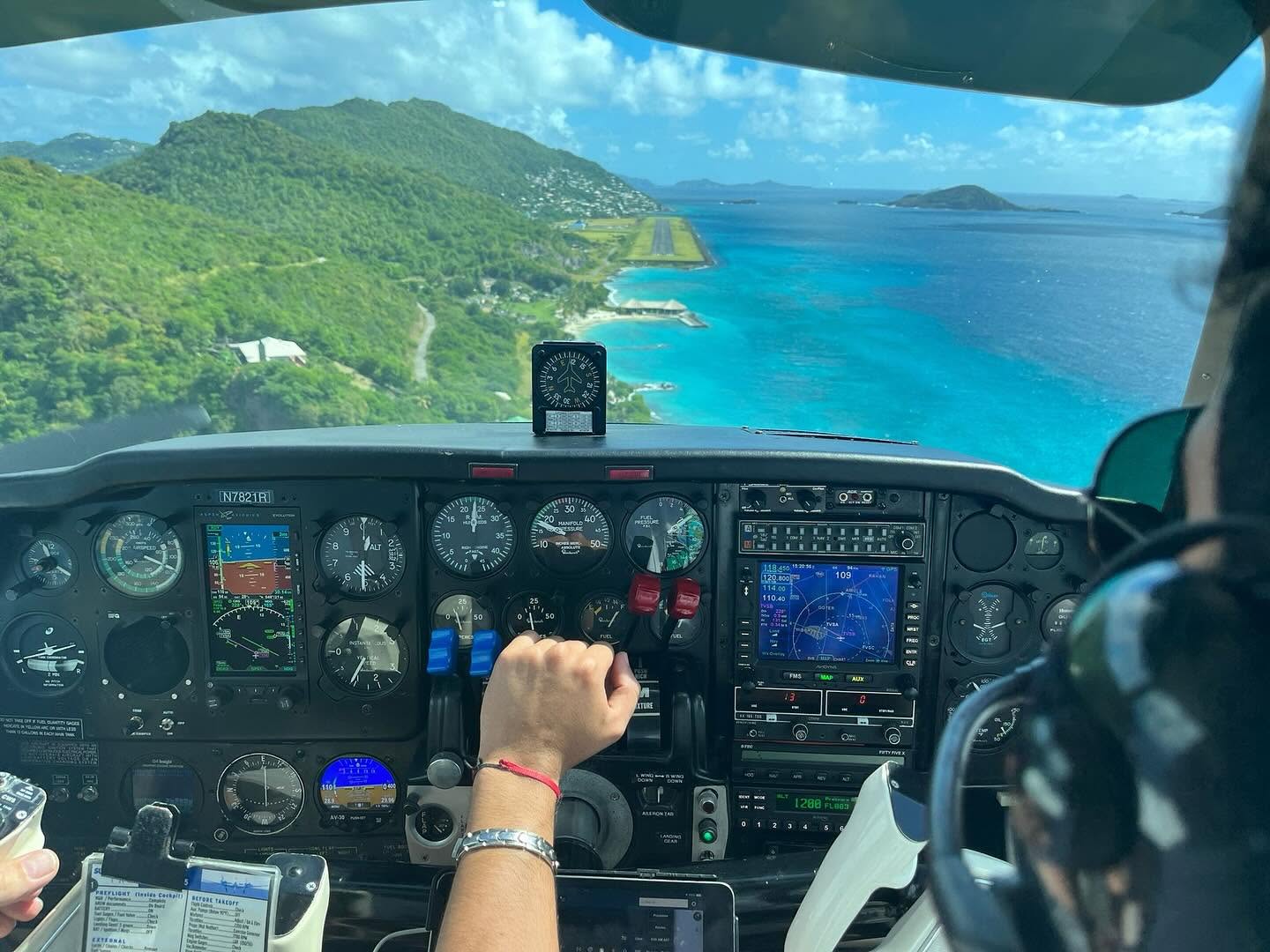 Cockpit view on approach to Bequia over turquoise water